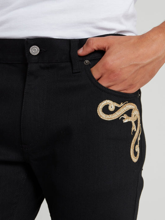 Черные джинсы с вышивкой в виде змеи