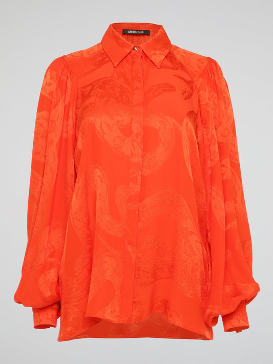 Unleash your wild side with this striking Orange Snake Print Blouse from the iconic Roberto Cavalli. Crafted with luxurious silk fabric, this statement piece features a bold snake print pattern that is sure to turn heads wherever you go. Embrace your inner fashionista and make a fierce style statement with this must-have addition to your wardrobe.