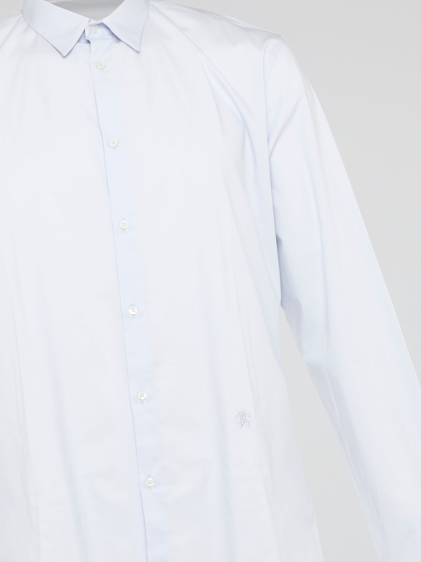 Elevate your wardrobe with the effortlessly chic White Long Sleeve Shirt by Roberto Cavalli. Crafted from luxurious fabric with impeccable attention to detail, this versatile piece exudes sophistication and glamour. Embrace a timeless look that seamlessly transitions from day to night with this must-have staple.