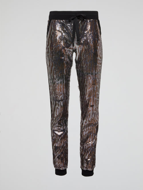 Feel fierce and fabulous in our Leopard Pattern Sequin Pants from Roberto Cavalli. These statement-making bottoms are sure to turn heads wherever you go, with their bold leopard print and shimmering sequins. Channel your inner wild side and stand out from the crowd in these show-stopping pants.