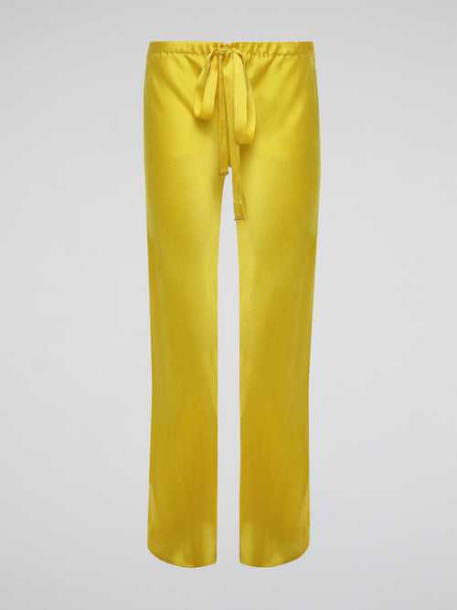 Step up your style game with these vibrant Yellow Drawstring Silk Trousers by Roberto Cavalli. Crafted from luxurious silk, these statement trousers offer a silky soft touch and a flowing silhouette that is both elegant and comfortable. Perfect for any occasion, let these eye-catching pants be the star of your ensemble.