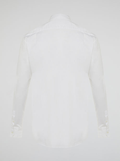 Step into a realm of elegance with the White Embroidered Shirt by Roberto Cavalli, where classic sophistication meets modern charm. Crafted with meticulous attention to detail, this shirt showcases exquisite floral embroidery that dances gracefully across the pristine white fabric. Embrace your inner fashion icon as you effortlessly blend timeless style with a touch of Italian flair, making a statement that is as timeless as it is enchanting.