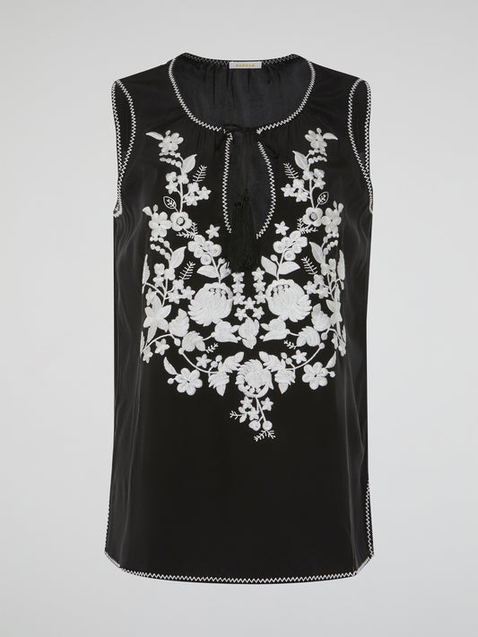 Step into a world of romantic charm with our mesmerizing Black Floral Embroidered Top by Parosh. Delicate blooms in rich hues beautifully cascade over the sheer fabric, creating a captivating visual play. This ethereal piece effortlessly blends sophistication with a hint of bohemian allure, making it a must-have for any fashion enthusiast.