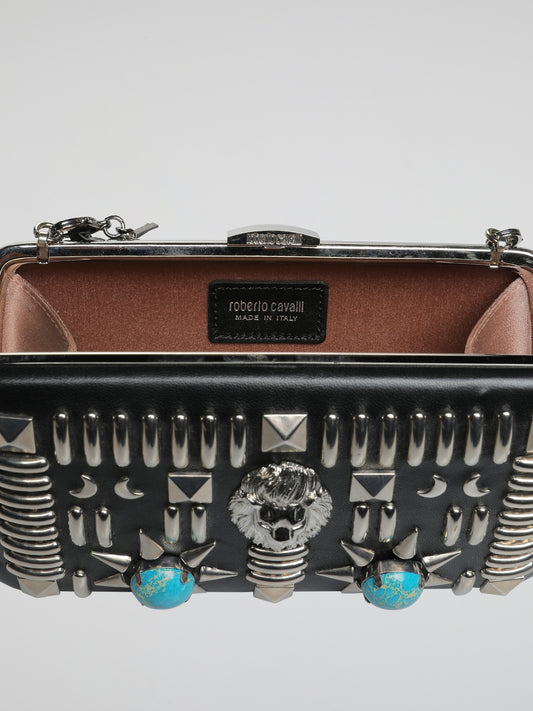 Introducing the Exquisite Embellished Leather Clutch by Roberto Cavalli - a true masterpiece that transcends the boundaries of style. Crafted with meticulous attention to detail, this clutch embodies the essence of timeless luxury. The stunning embellishments and supple leather make it an absolute must-have accessory for the fashion-forward individuals who dare to make a statement.