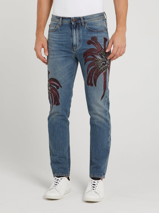 Синие джинсы с тропическим принтом